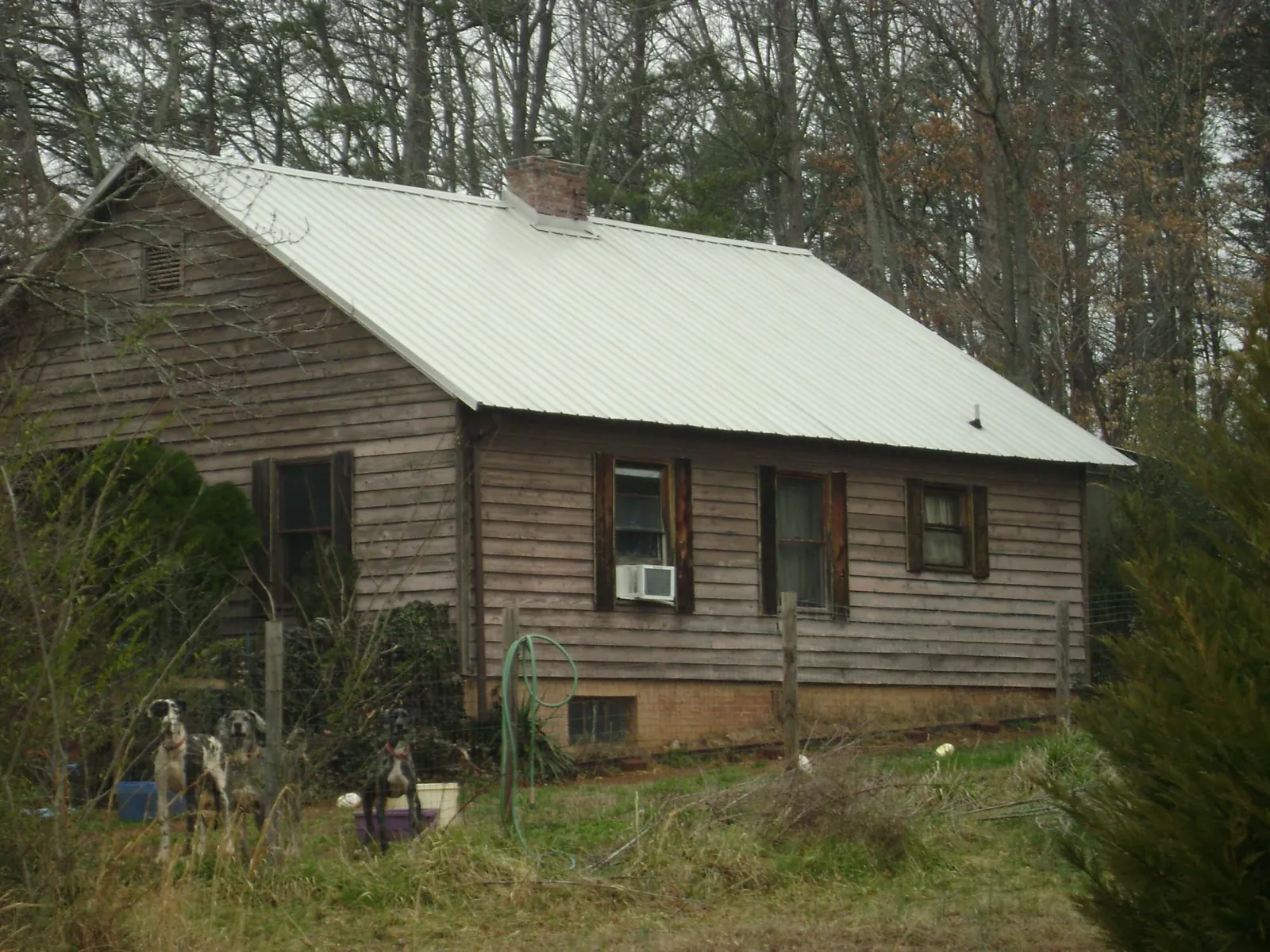 White metal roof on an old wood sided farmhouse, from a Metal Roof Installation job in Artois